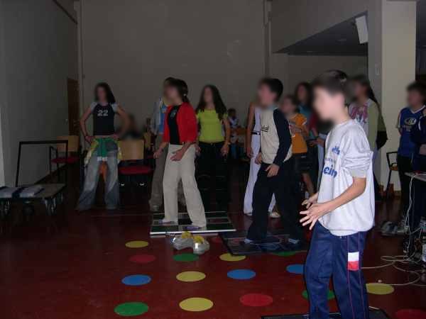 Kids dance on pads in rows at an after-school program in Spain