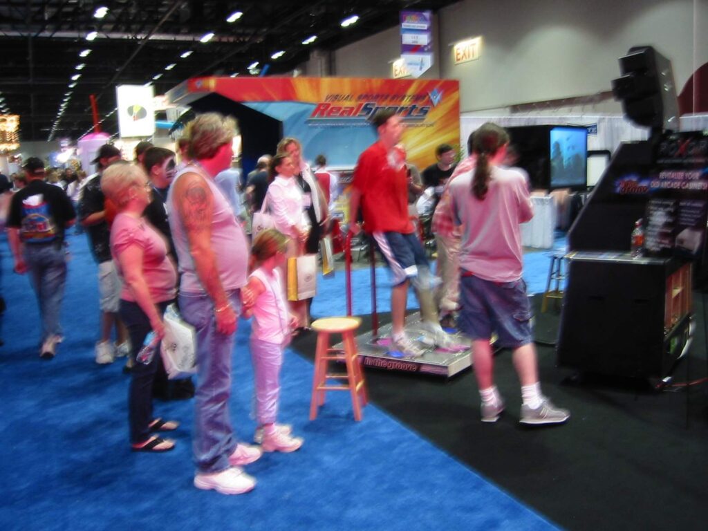 Kids and parents line up for a turn at a dance game